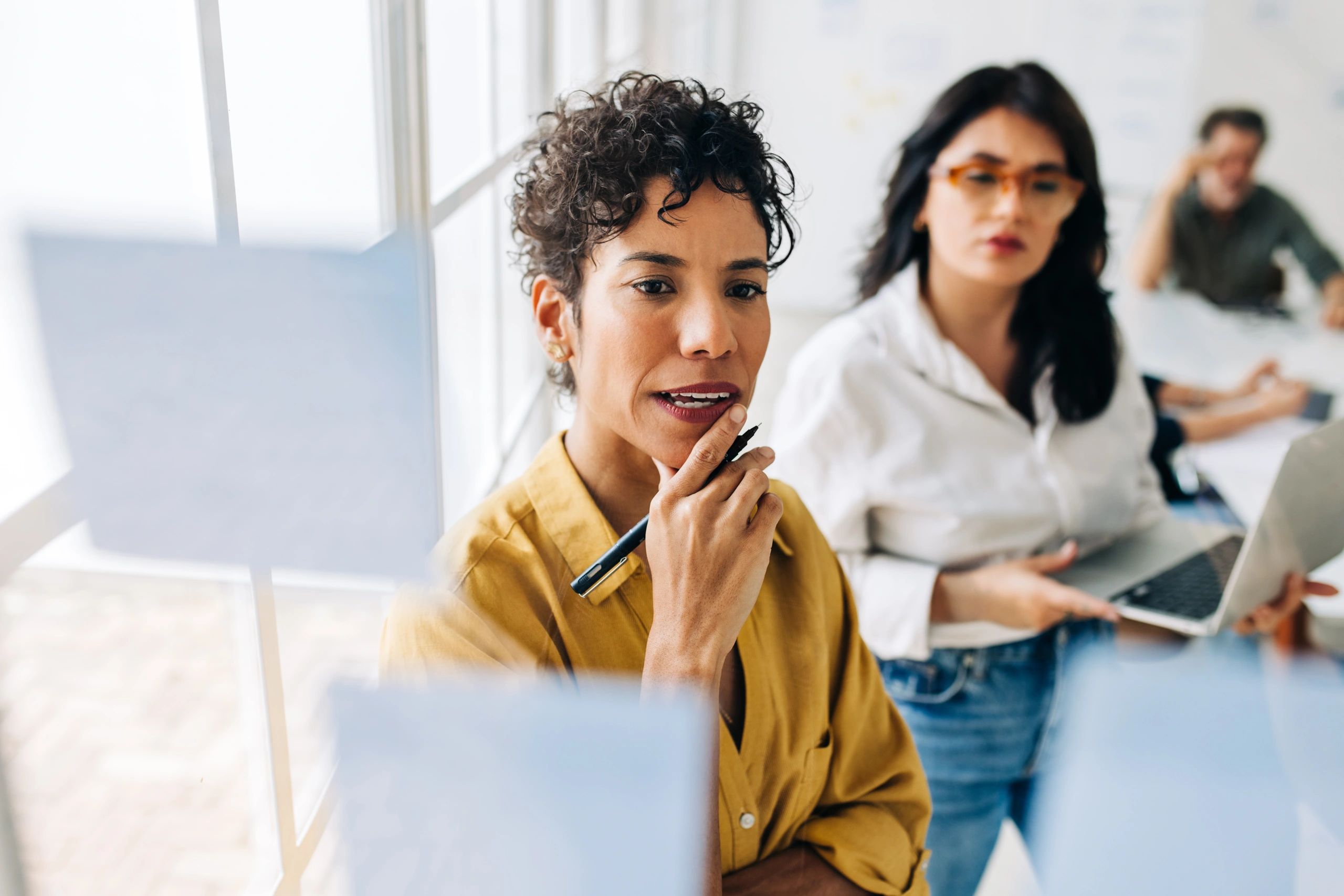 Business women brainstorming with sticky notes in an office